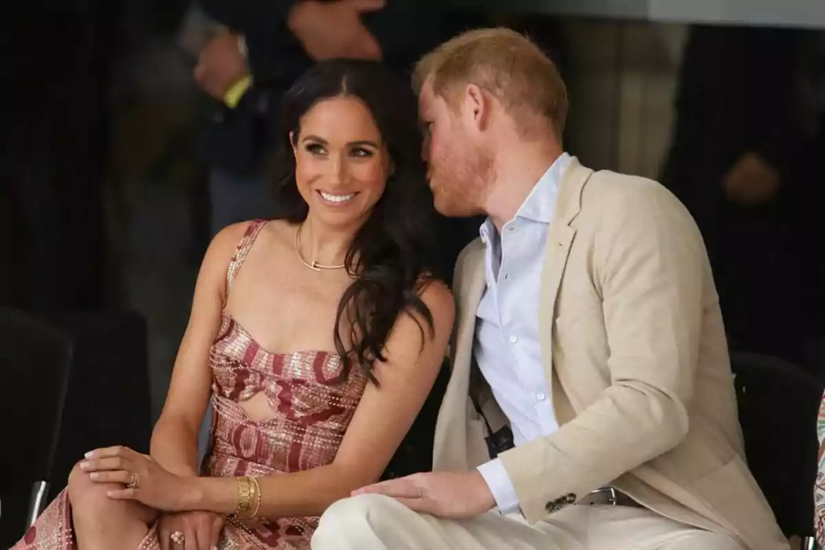 Photo of Prince Harry speaking into Meghan Markle's ear during the performance of the Danza Pies del Sol theatre group. Photo of Prince Harry speaking into Meghan Markle's ear during the performance of the Danza Pies del Sol theatre group.